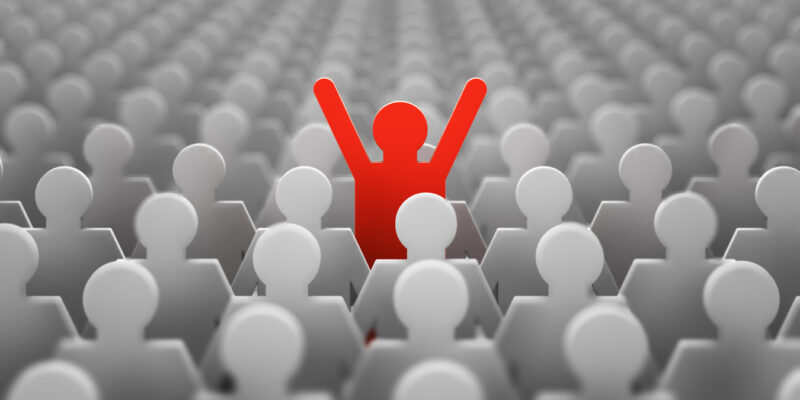 The symbol of a leader in the form of a red man with his hands up in a crowd of white men. 3d render