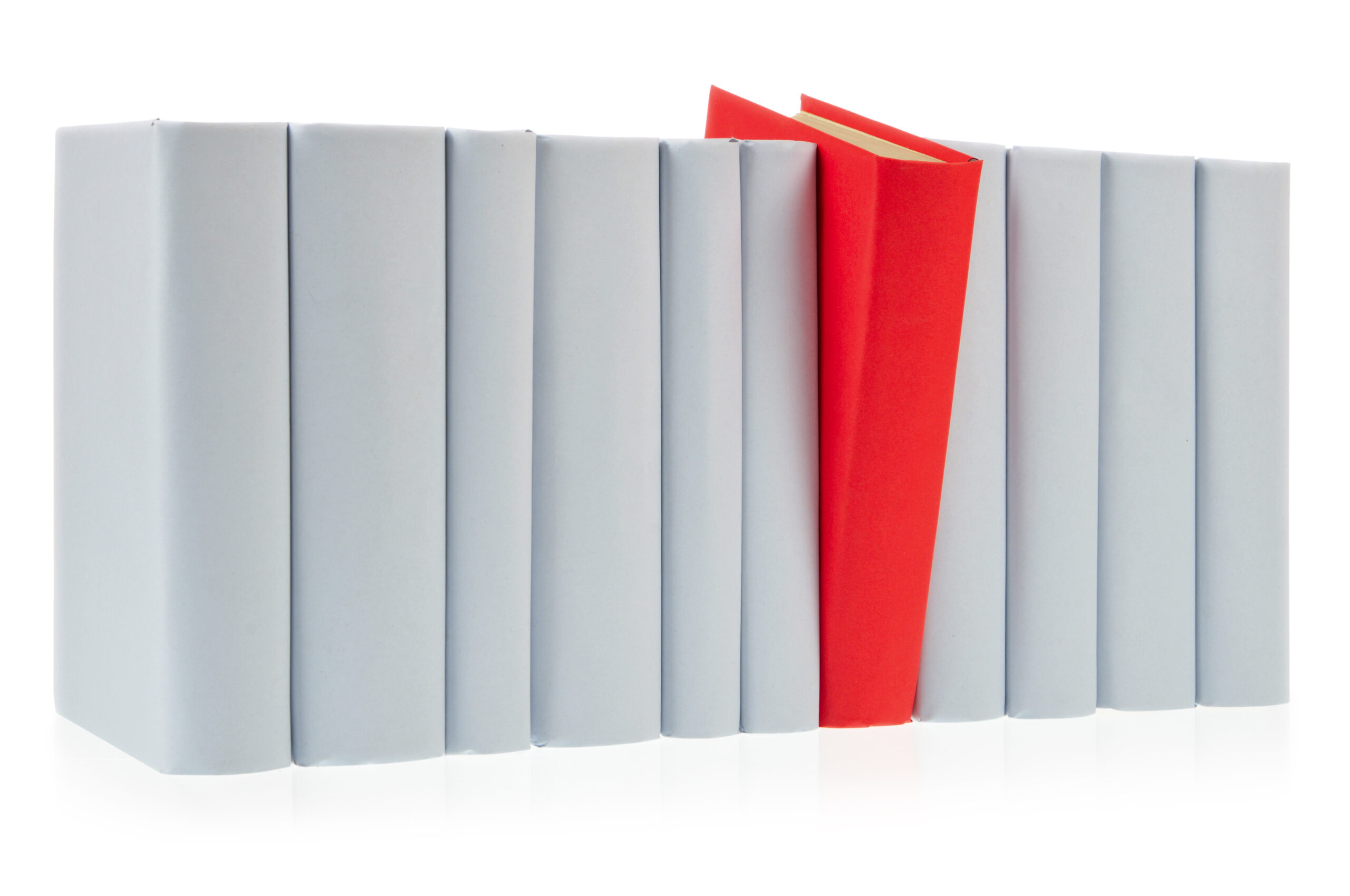 Red book falls out of row of grey books