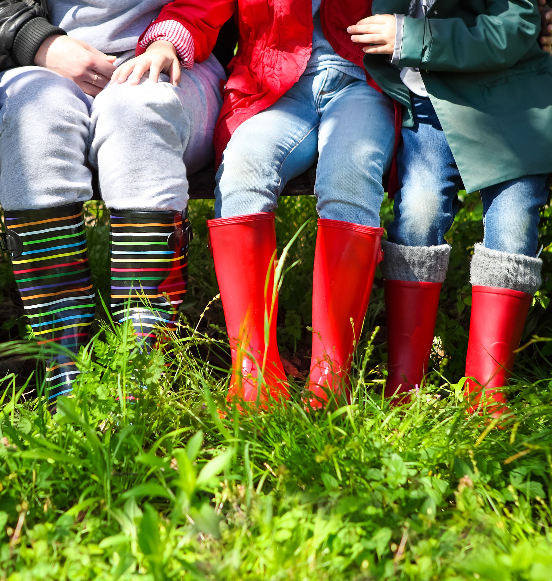 Happy family wearing colorful rain boots